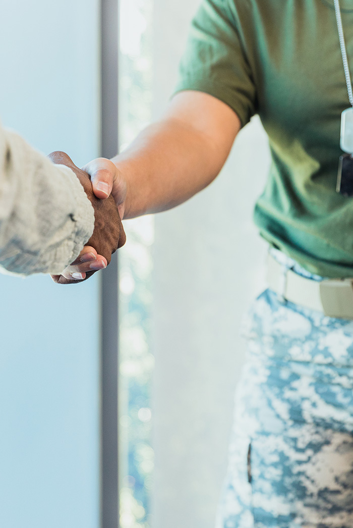 Veteran shaking hands with person out of frame