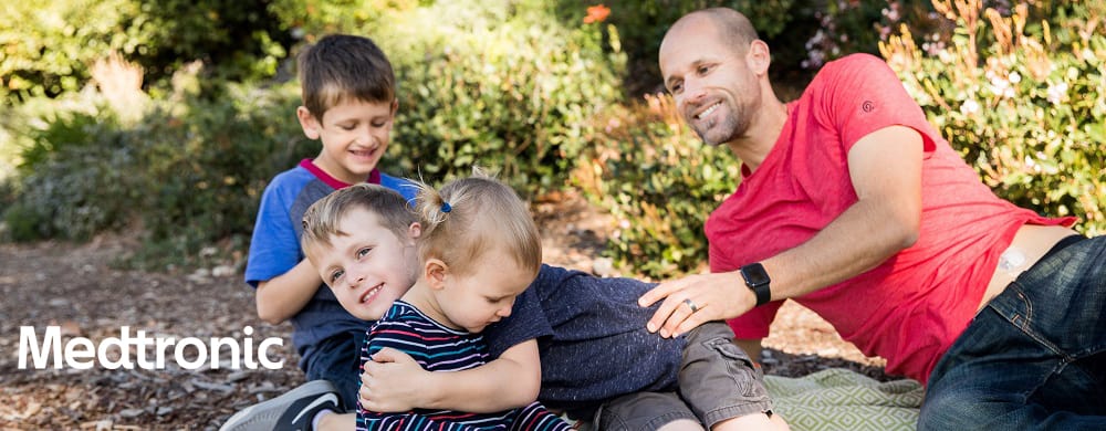 Father playing with children outside